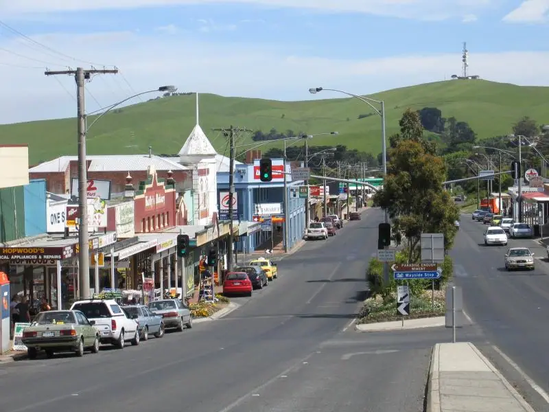 The main street of Korumburra with green hills behind