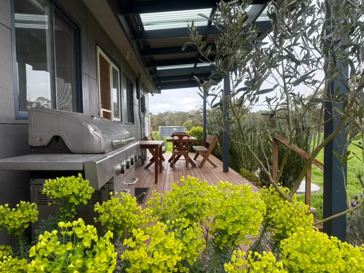 Outdoor dining area on the deck at Prom Coast Residence