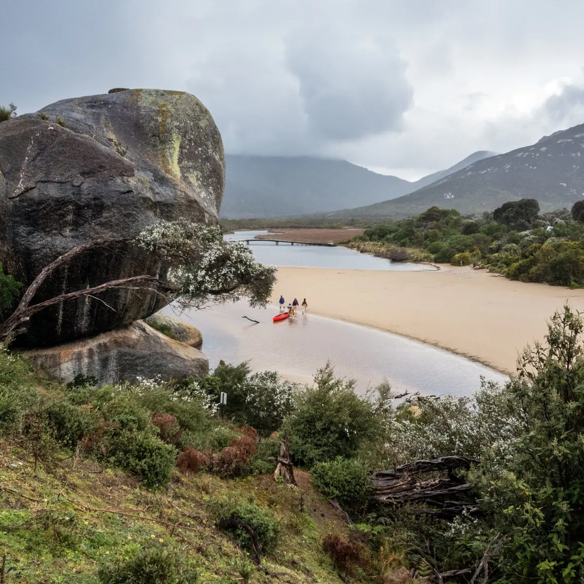 A granite boulder above the sandy mouth of a river at Wilsons Promontory